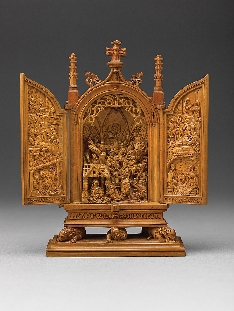Miniature altarpiece (triptych) AGO 34208, shown with wings open. The scenes carved in low relief on the wings relate to the scene of the Adoration of the Magi in the central carving