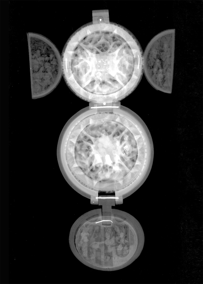 Prayer bead AGO 29361.  Metal pins appear as straight and bent lines in the X-radiograph exposing the location of the five pins used to secure the two exterior shells, two wings and disc